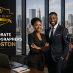 Corporate photography promotional banner showing two business professionals posing for a photoshoot in a modern office with a city skyline backdrop and the headline “Corporate Photographers in Boston.”